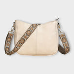 Sac bandoulière vegan blanc cassé, fermeture zippée et sangle à motif décoratif.