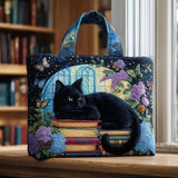 Sac cabas matelassé bleu avec chat noir sur livres et motifs fleurs, anses contrastées