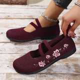 Chaussures plates bordeaux à brides croisées, motif floral brodé sur le dessus.