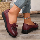 Mocassins bordeaux à nœud, semelle crantée, détail floral sur le dessus, vue de côté.