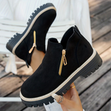 Bottines noires suédées avec double zip doré et semelle crantée épaisse.