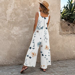 Combinaison longue à bretelles blanches imprimées, fleurs et feuillages bleus sur la jambe
