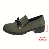 Mocassins à semelle souple vert en daim, nœud noir, bride arrière, talon bloc