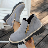 Bottines grises suédées à double zip doré et semelle crantée, bord blanc.