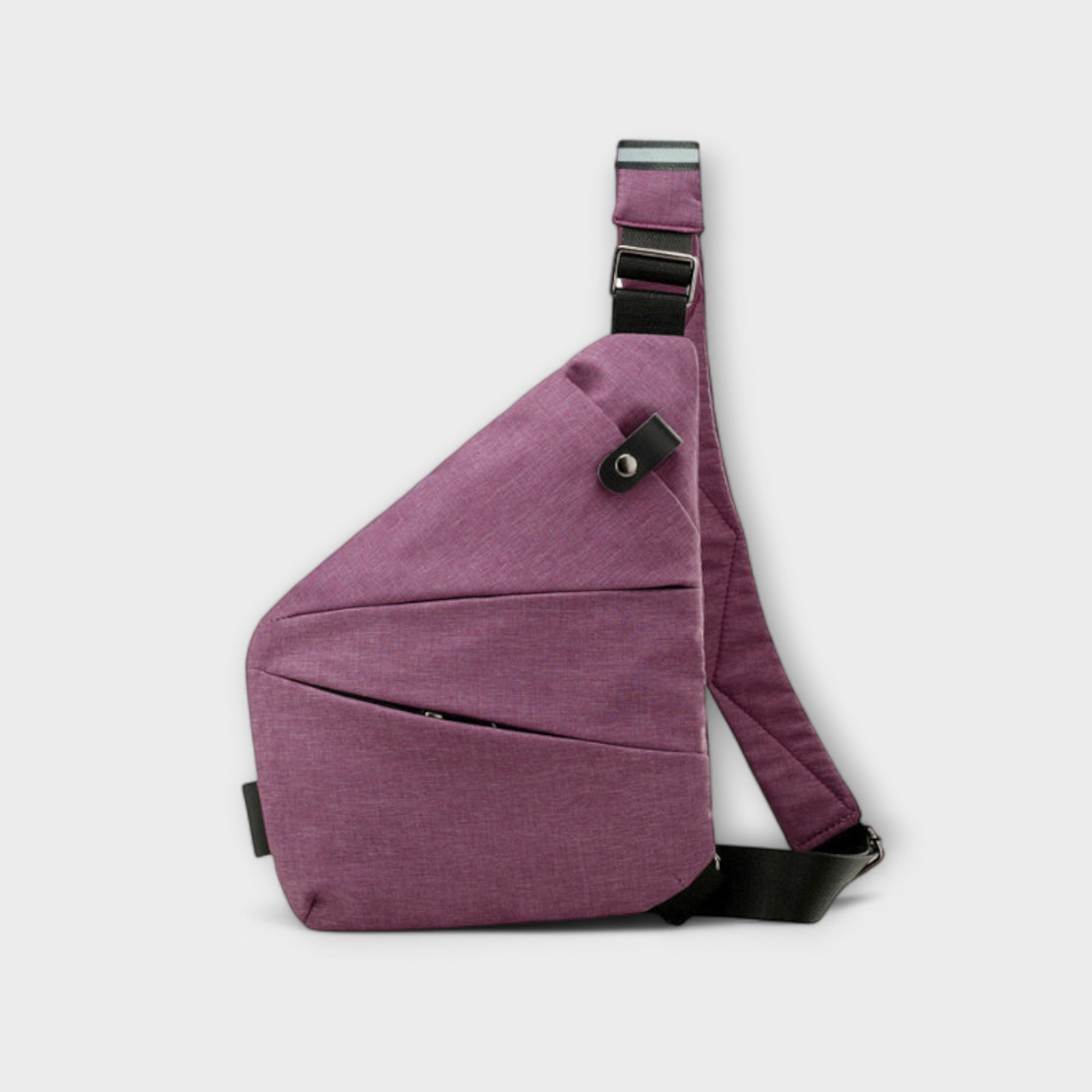 Sac à bandoulière anti-vol prune, bandoulière réglable et détails en métal sur la face.