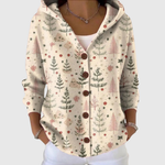 Cardigan en tricot à capuche beige clair, motif sapins et étoiles, boutonné.