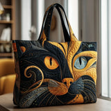 Sac cabas artisanal en tissu matelassé noir et doré, motif chat stylisé
