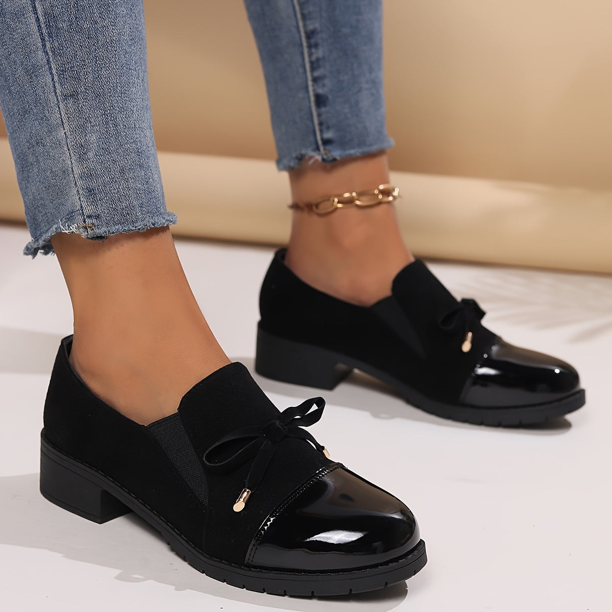 Mocassins Nadège noirs à talon bloc, semelle crantée et nœud sur le dessus.