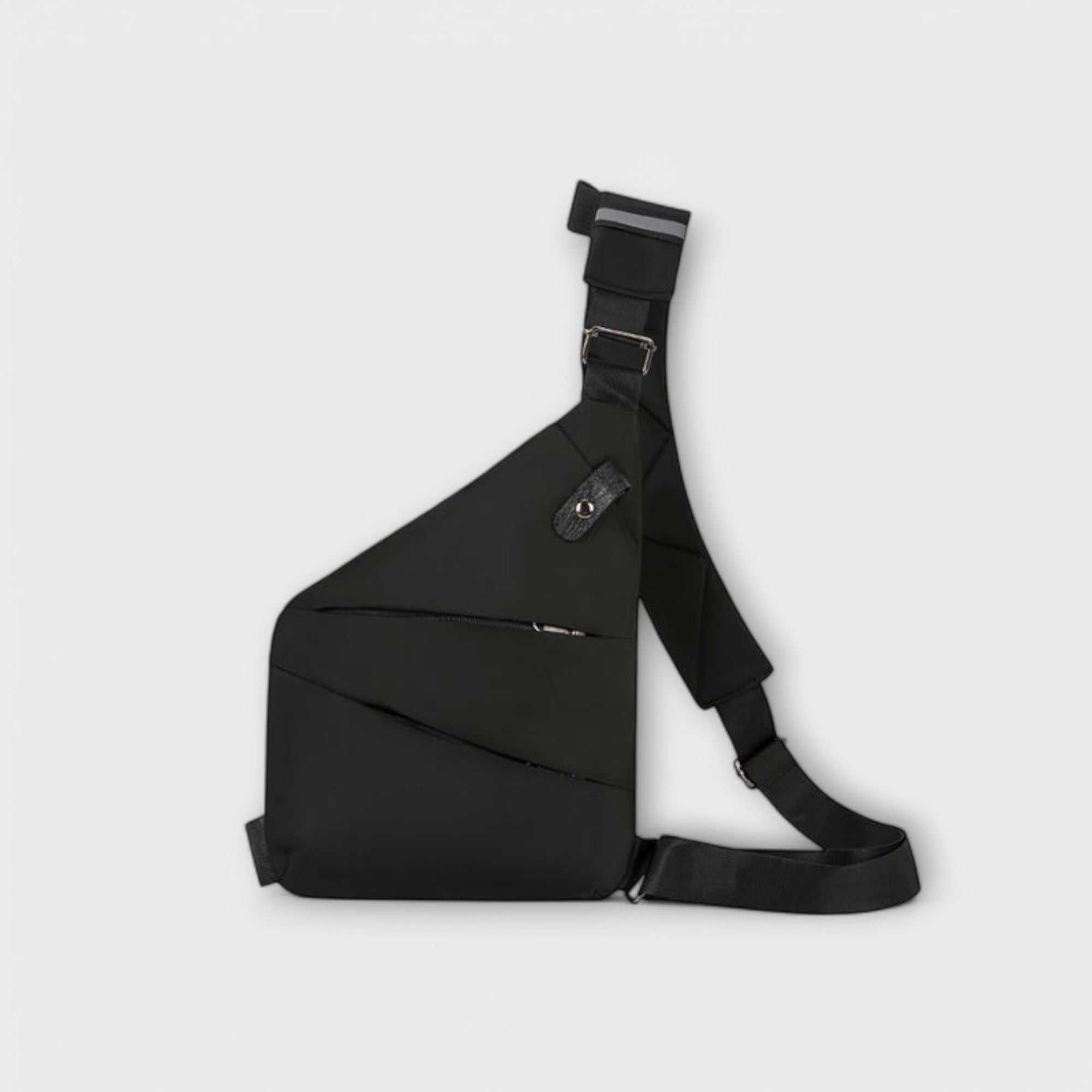 Sac à bandoulière anti-vol noir, porté en travers avec sangles réglables et poche latérale.