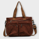 Sac cabas Aveline marron en toile, anses et bandoulière, poches zippées.