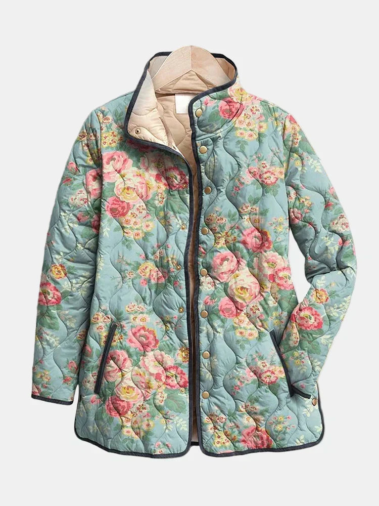 Veste matelassée à imprimé floral multicolore, bleu clair, capuche doublée, boutonnée.