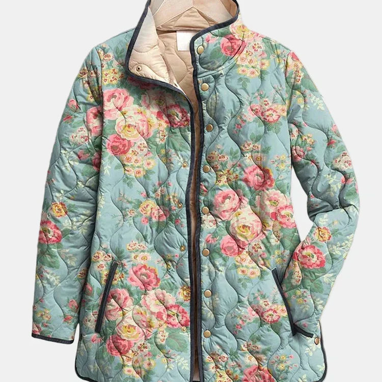Veste matelassée à imprimé floral multicolore, bleu clair, capuche doublée, boutonnée.