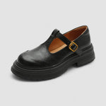 Chaussures salomés noires à bride avec boucle dorée et semelle crantée