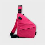 Sac à bandoulière anti-vol fuchsia, bandoulière réglable et poche zippée en diagonale.