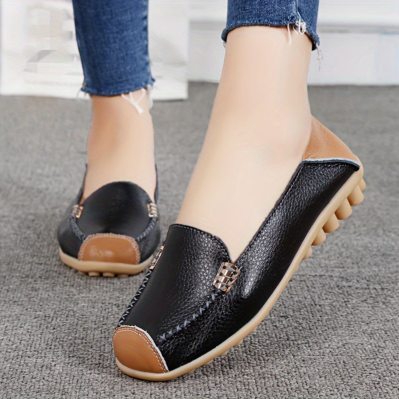 Mocassins noirs à boucle métal, surpiqûres contrastées et semelle beige