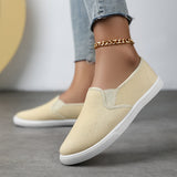 Chaussures souples à enfiler beige clair, chaînette dorée à la cheville, semelle blanche.