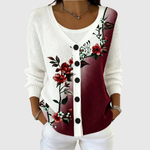 Cardigan en tricot blanc à boutons noirs, motif floral rouge et bordeaux sur le devant