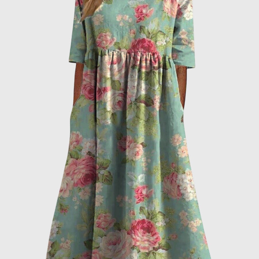 Robe flatteuse vert menthe à fleurs roses, manches courtes, taille smockée.