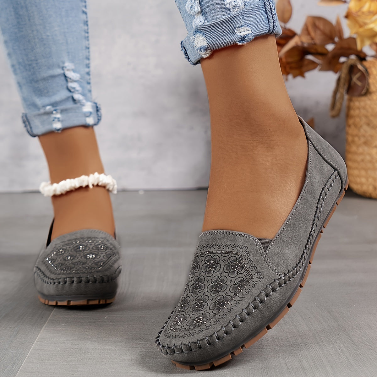 Mocassins gris ajourés, motif floral sur l’avant et semelle épaisse crantée.