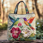Sac matelassé crème avec hirondelles multicolores et fleurs brodées, anses noires.