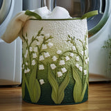 Panier à linge en tissu vert brodé de fleurs blanches