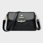 Sac à bandoulière noir en cuir tressé, rabat avec fermoir fleur, logo BALDASHU