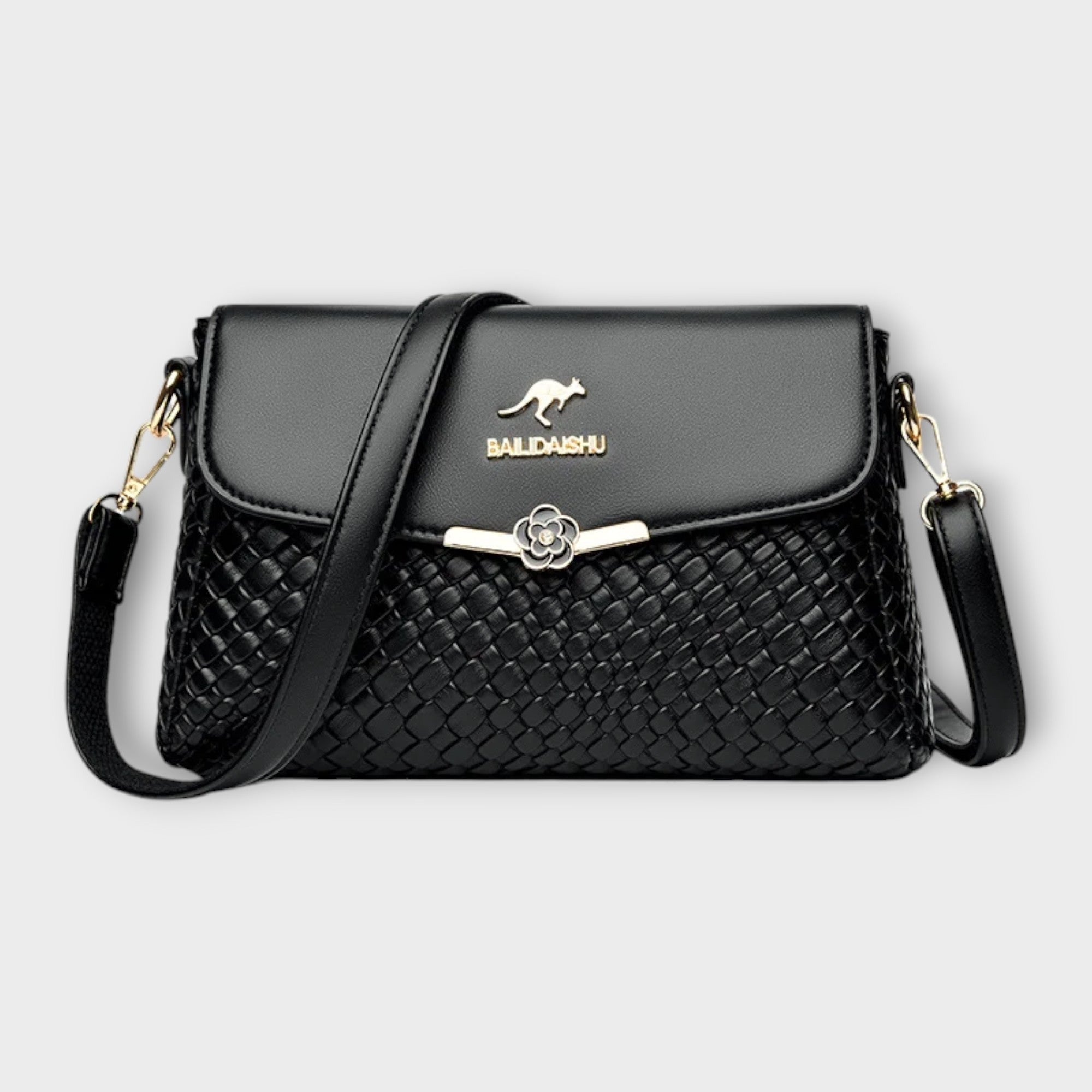 Sac à bandoulière noir en cuir tressé, rabat avec fermoir fleur, logo BALDASHU