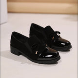Mocassins Nadège noirs vernis, talon bloc, nœud et semelle épaisse.
