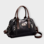 Sac à bandoulière vintage en cuir noir, anses rigides, poche zippée frontale