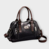 Sac à bandoulière vintage en cuir noir, anses rigides, poche zippée frontale