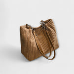 Sac à bandoulière en cordon doux beige, anses courtes et bandoulière amovible.