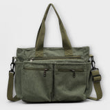 Sac cabas Aveline vert en toile, double poches zippées et bandoulière réglable.