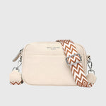 Sac à bandoulière en cuir beige, fermeture zippée, bandoulière à motif géométrique.