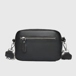 Sac à bandoulière en cuir noir, fermeture zippée visible, bandoulière et attaches métalliques.