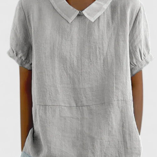 Chemise élégante blanche à manches courtes bouffantes, col à pointe, couture à la taille