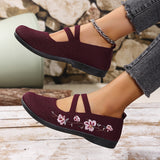 Chaussures plates bordeaux à brides croisées, broderie florale rose sur le dessus.