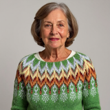 Pull en laine vert à col rond blanc, motifs jacquard colorés au buste.