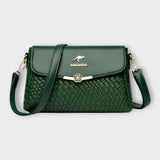 Sac à bandoulière vert en cuir tressé, rabat avec fermoir fleur, logo BALDASHU