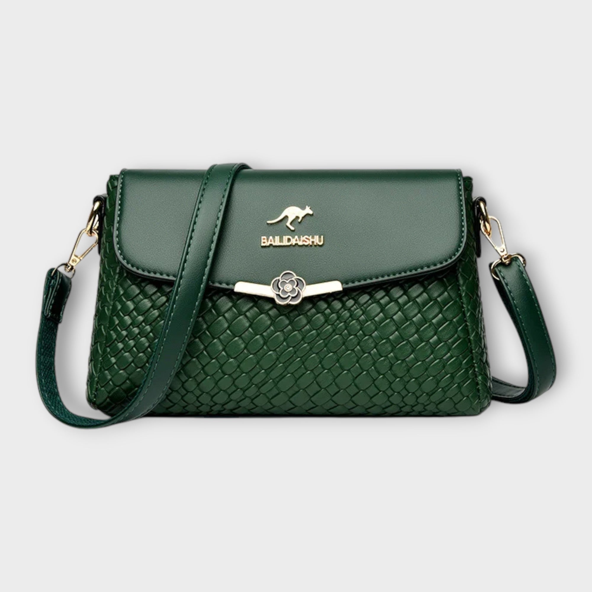 Sac à bandoulière vert en cuir tressé, rabat avec fermoir fleur, logo BALDASHU