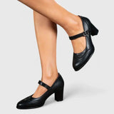 Chaussures bébé à talon noir, bride ajustable à boucle, dessus en cuir lisse
