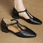 Chaussures à bride réglable noires, brides tressées et boucle sur le dessus.