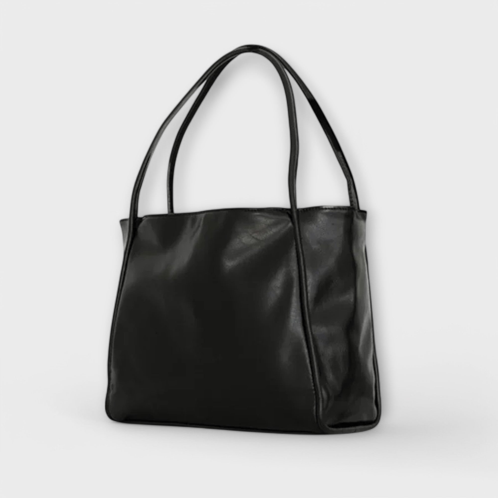 Sac Néréa Blair noir à anses, cuir lisse brillant, forme cabas avec devant plat